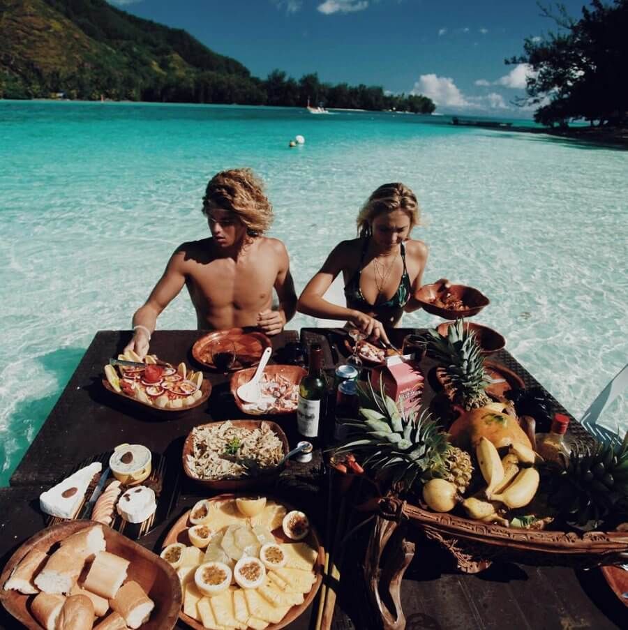 um homem e uma mulher colhem comida fresca no meio do oceano